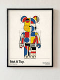 Not A Toy fine art print in black frame by HOOKD Studio