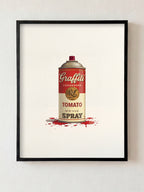 Framed artwork of a can labeled 'Graffiti Tomato Spray' on a white wall.