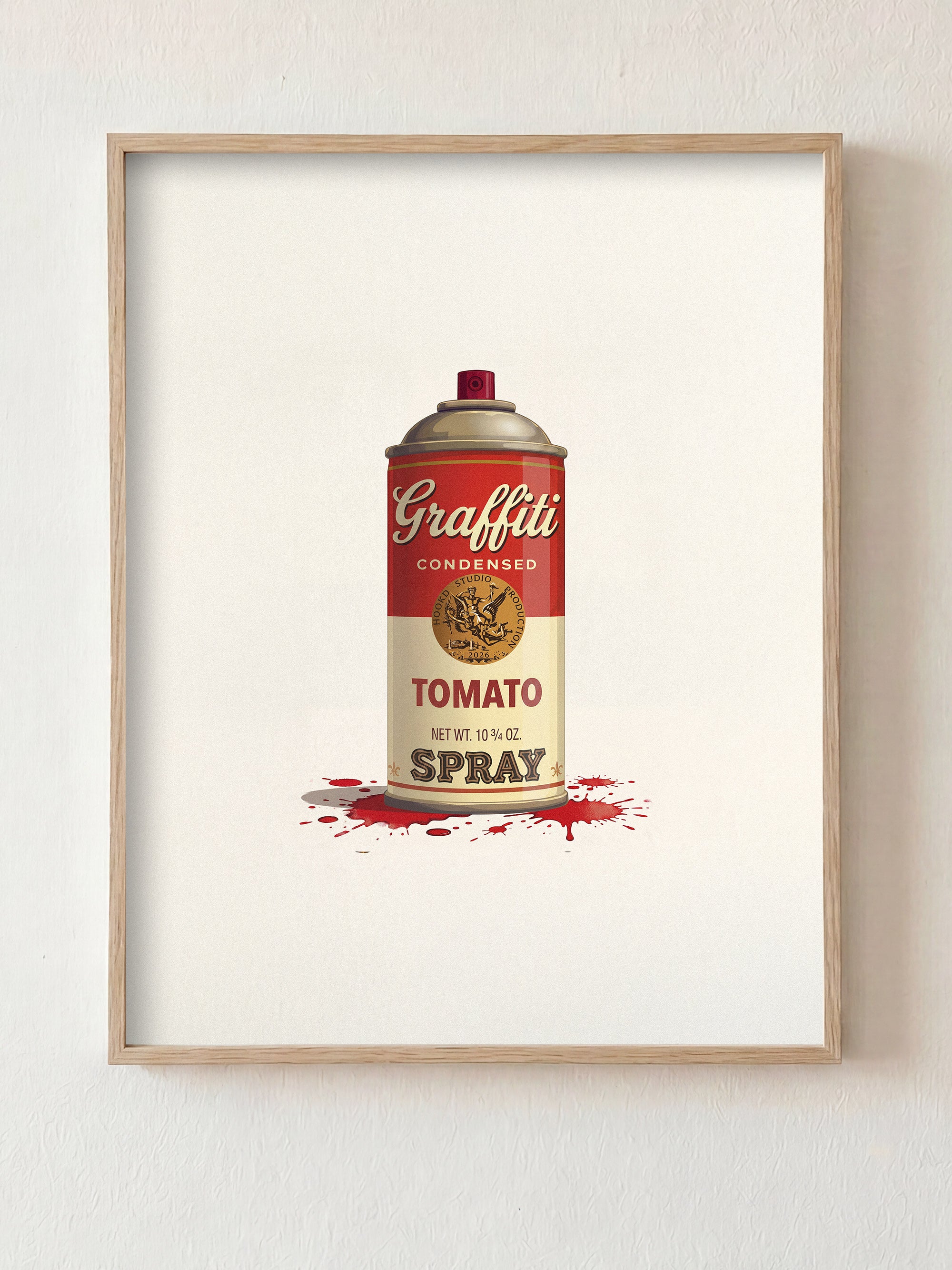 Framed artwork of a can labeled 'Graffiti Tomato Spray' on a white wall.